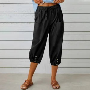 Detail of black cotton linen cropped pants with drawstring waist and buttoned cuffs