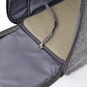 Interior detail of pet carrier bag featuring fleece mat and safety leash tether