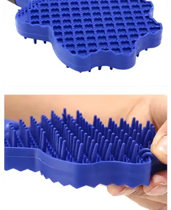 Close-up detail of blue silicone pet grooming brush showing soft bristles and handle texture