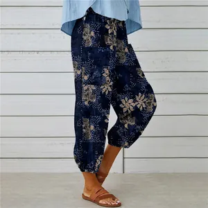 Close-up of vintage floral print cotton linen trousers with elastic cuffs and drawstring.