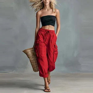Full body view of women's red high street cargo pants with loose wide-leg fit