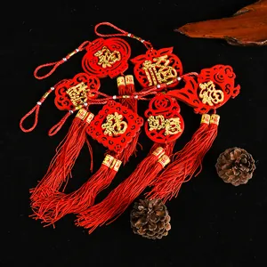 Detailed view of red felt Chinese New Year ornaments with gold Fu characters and tassels.