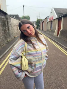 Detailed look of the colorful striped hooded knit cardigan on a model