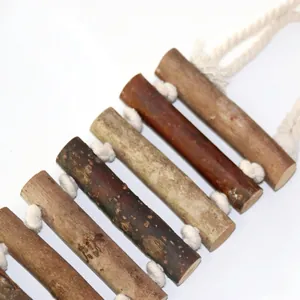 Close-up detail of natural wood parrot ladder bridge with cotton rope knots