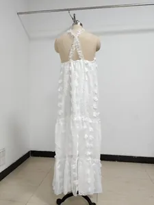 Back view of white tiered maxi dress with 3D floral lace and halter cross-back straps