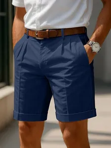 Elegant men's navy blue business casual shorts featuring a pleated front and cuffed hem detail