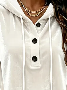 Close-up view showing the white crushed velvet fabric and button detail of the hoodie