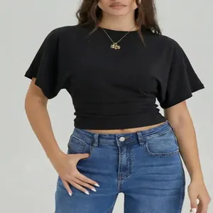 Elegant minimalist black short-sleeved crew neck crop top paired with classic blue jeans