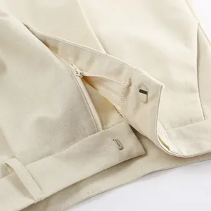 Close-up detail of khaki linen shorts featuring a sturdy zipper and metal hook closure