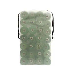 Detailed view of green biodegradable dog poop bag rolls in a frosted drawstring storage bag
