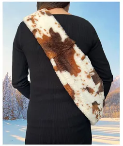 Detail view of plush cow print pet sling carrier for winter travel with small dogs
