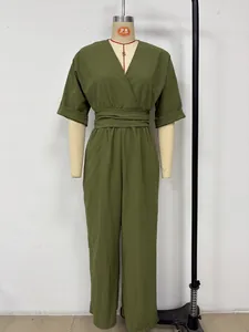 Elegant olive green V-neck jumpsuit with waist-cinched design displayed on a mannequin