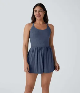 Full view of a stylish ladies sleeveless blue romper dress showing fit and fabric details