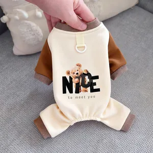 Detailed view of cream and brown pet pajamas featuring a cute teddy bear and leash ring.