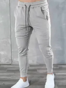 Light gray men's athletic cotton joggers featuring drawstring waist and slim fit design