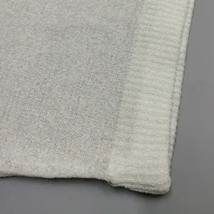Close-up of white knit fabric texture and ribbed hem detail for women's fashion set