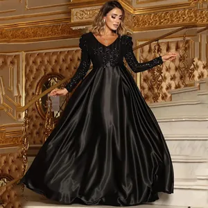 Detail of black deep V-neck evening gown with sequins and satin floor-length skirt.