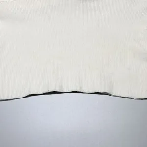 Detailed close-up view showing the white ribbed knit fabric texture of a women sweater