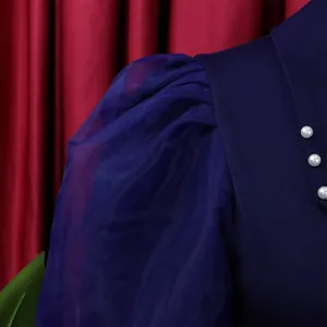 Close-up of navy blue mesh puff sleeve and pearl bead details on pencil dress