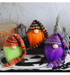 A set of three colorful Halloween gnomes with long knitted hats and plush beards decoration