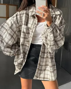Detailed view of women's oversized vintage plaid shirt paired with a black mini skirt