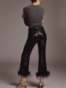 Elegant black sequined trousers with luxury feather trim detail for evening gala wear