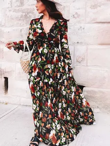 Elegant long-sleeved floral maxi dress with ruffle V-neck and flowing layered skirt design