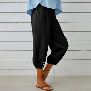 Detail of women's casual black cotton linen cropped jogger pants with buttoned cuffs