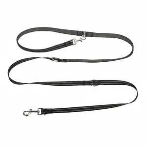 Detail of black hands-free pet leash with reflective stitching and metal hooks
