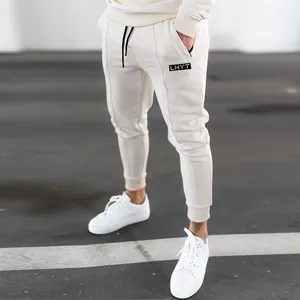 Detailed view of off-white men's fitness joggers paired with white sneakers