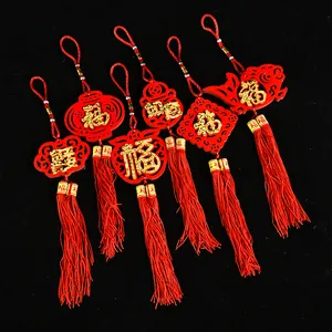 Detailed view of red felt Chinese Lunar New Year ornaments with golden characters and tassels