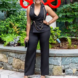 Detail view of elegant black sleeveless jumpsuit with gold chains and wide leg pants