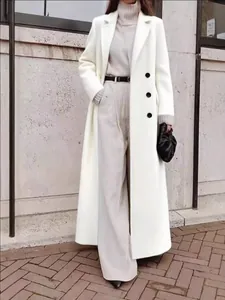 Elegant long white wool coat with black buttons for women's minimalist winter fashion style
