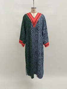 Detailed view of a V-neck color-block maxi dress with digital circular prints.