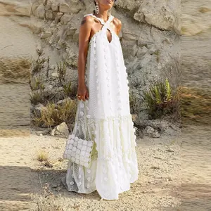 Elegant white floor-length tiered dress featuring 3D floral details and a halter neck design