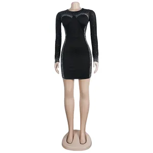 Close-up view of a black long sleeve bodycon dress with rhinestone and mesh details