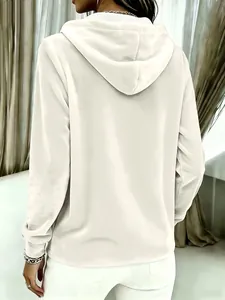 Back view detail of a women's cream gold velvet hooded sweatshirt with a loose fit