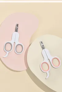 Close-up of pet nail clippers in grey and pink variations on pastel backgrounds