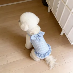 Detailed back view of a blue gingham dog dress with a cute bow and ruffle hem