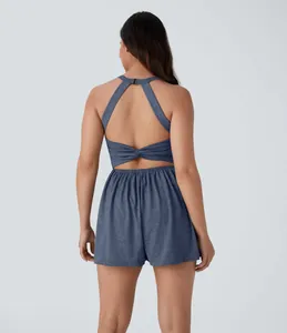 Back view of a blue sleeveless halter romper with stylish twist detail and open back