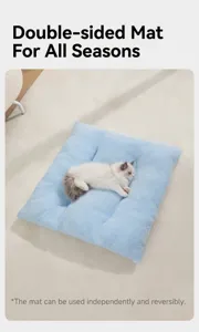 Close-up of a blue plush pet mat with a white cat, highlighting the soft texture.