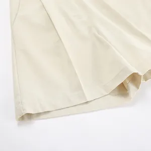 Detailed view of the high-quality linen-cotton fabric hem on beige summer shorts
