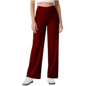 Detail view of women's high-waist straight-leg yoga pants in dark red color