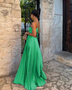 Back view detail of vibrant green pleated maxi dress with elegant spaghetti straps