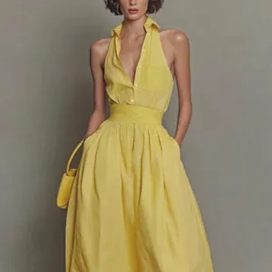 Detailed view of yellow striped V-neck sleeveless maxi dress with belted waist