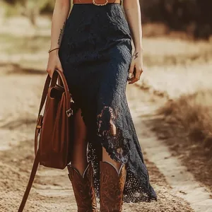 Detail of a blue lace bohemian midi dress with vintage leather belt and cowboy boots.