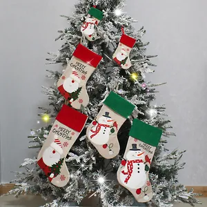 Set of festive Christmas stockings with Santa and snowman for holiday tree decoration