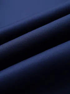 Macro shot of navy blue knit fabric showing high-density texture and subtle sheen details