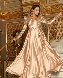Detailed view of an elegant rose gold evening gown with deep V-neck and sequined bodice