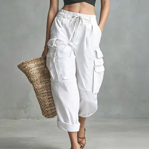 Detailed view of white high-waisted cargo pants with drawstring and side pockets